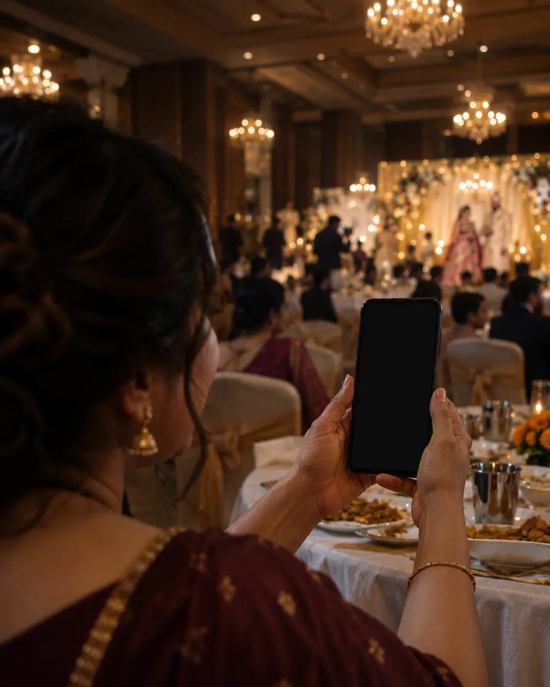 A wedding guest at a reception showing the people at her table the photos she just got on her phone